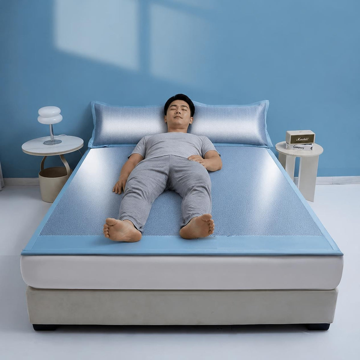 Man sleeping comfortably on the NightNest Ice Silk Cooling Mattress Pad